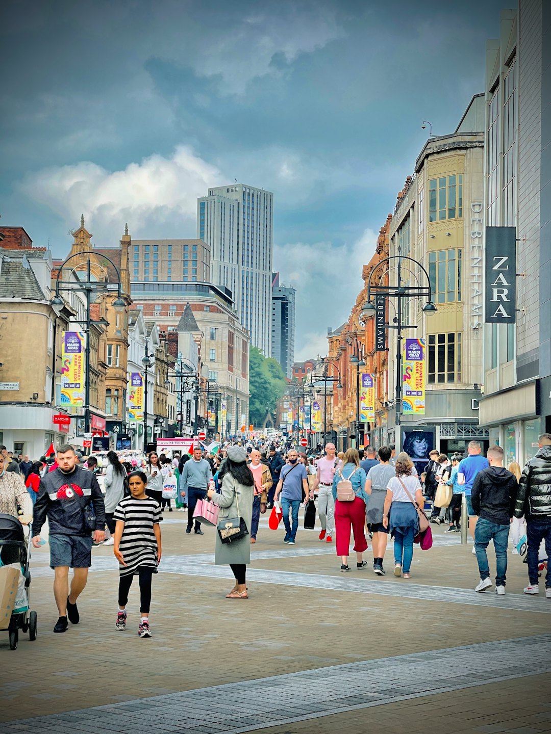 Diverse crowd shops on a bustling city street.